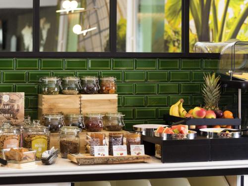 a display of food in jars on a counter at Aparthotel Adagio Brussels Grand Place in Brussels