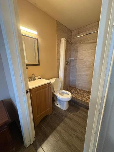 a bathroom with a toilet and a sink and a shower at SE'Air Motel By Townhouse Corpus Christi - Padre Island Tx in Corpus Christi