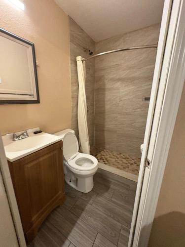 a bathroom with a toilet and a sink and a shower at SE'Air Motel By Townhouse Corpus Christi - Padre Island Tx in Corpus Christi