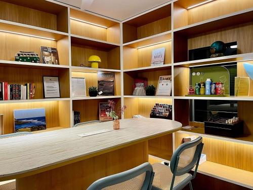 a library with a desk and chairs in it at Mercure Président Biarritz Plage in Biarritz