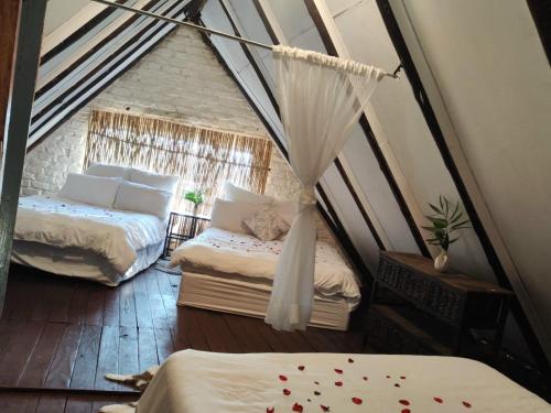 a room with two beds in a tent at Pamensky Bush Lodge and Spa in Hartbeespoort