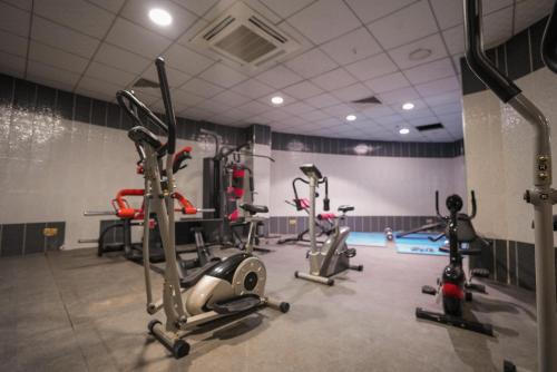 a gym with several exercise bikes in a room at Hotel Seever in Erbil