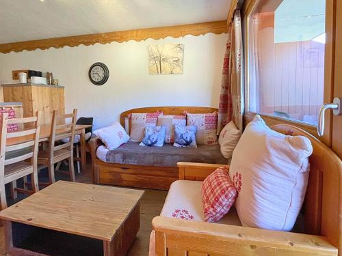 a living room with a couch and a table at Appartement aux Menuires avec cuisine équipée, balcon et animaux admis - FR-1-452-15 in Les Menuires