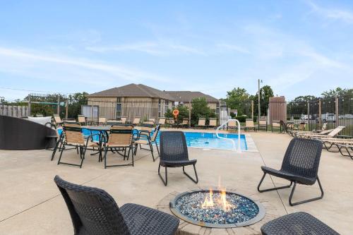 a patio with chairs and a table and a pool at Lighthouse Lodge 4 in Kimberling City