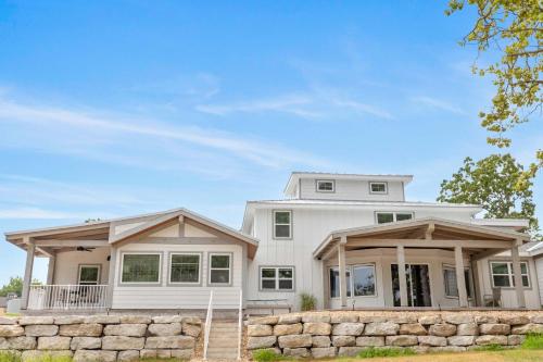 a white house with a stone wall at Lighthouse Lodge 4 in Kimberling City