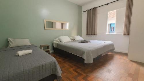 Ένα ή περισσότερα κρεβάτια σε δωμάτιο στο Casa Ipanema - Praia e Amigos, 13 hóspedes