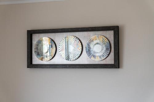 a framed picture of three plates on a wall at Departamento Calama in Calama