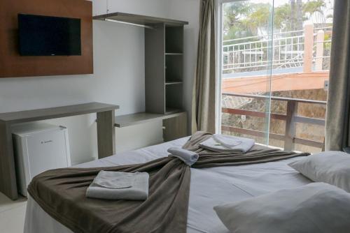 Katil atau katil-katil dalam bilik di Tarumã Búzios Hotel