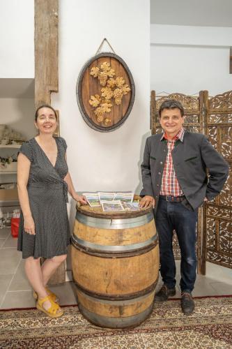 a man and a woman standing next to a barrel at Loft de charme 4 étoiles confort haut de gamme garage privatif in Barr
