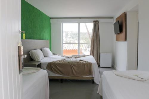 Katil atau katil-katil dalam bilik di Tarumã Búzios Hotel