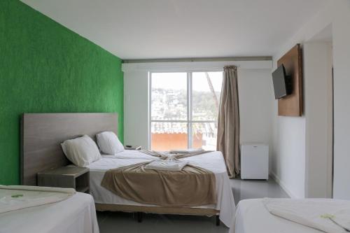 Katil atau katil-katil dalam bilik di Tarumã Búzios Hotel