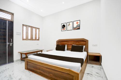 a bedroom with a large bed in a room at Hotel O Vrindavan Gardan & Hotel in Prayagraj