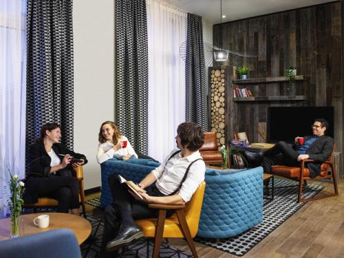 a group of people sitting in chairs in a room at Aparthotel Adagio Berlin Kurfürstendamm in Berlin