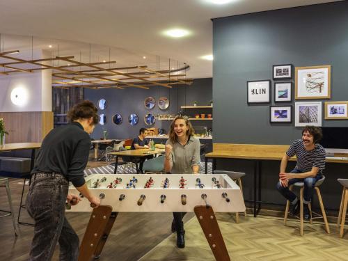a group of people playing with a large pool table at Aparthotel Adagio Berlin Kurfürstendamm in Berlin