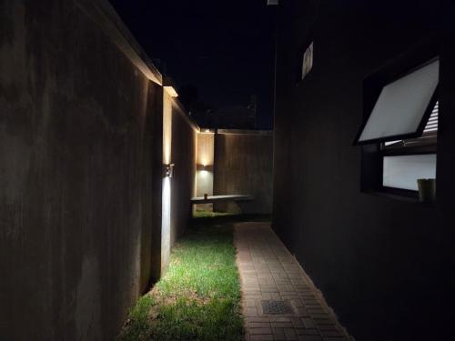 a dark hallway with a light at night at East Park Inn in Polokwane
