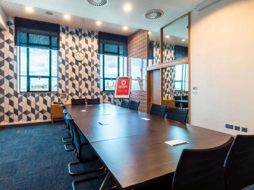 a conference room with a large wooden table and chairs at Aparthotel Adagio Liverpool City Centre in Liverpool