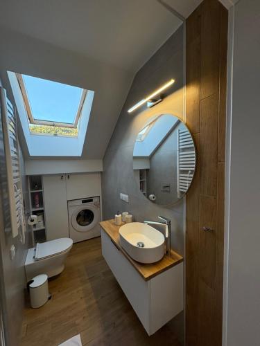 a bathroom with a sink and a mirror at Babia Perła Zawoja in Zawoja