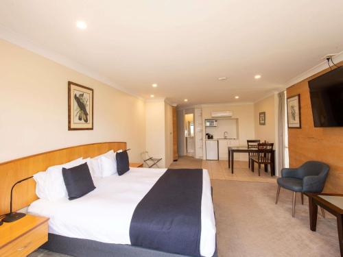 a hotel room with a large bed and a television at Mercure Kangaroo Island Lodge in American River