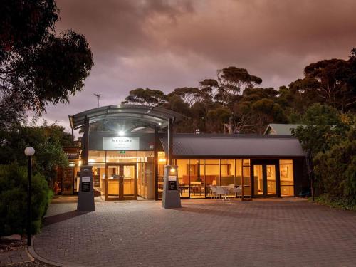 a building with a lit up front at night at Mercure Kangaroo Island Lodge in American River
