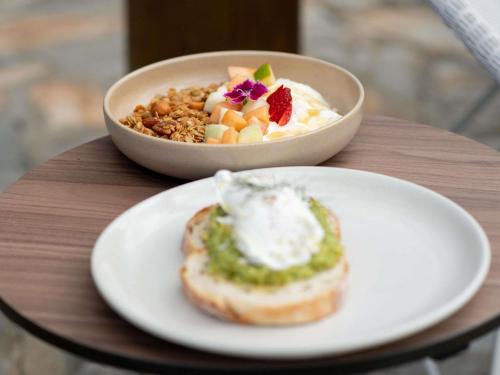 a bowl of food and a plate of food on a table at Mercure Kangaroo Island Lodge in American River