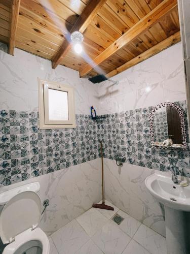 a bathroom with a toilet and a sink at Lighthouse Seaview Studio in Dahab
