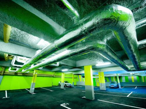 a parking lot with cars parked in a parking garage at ibis Styles Brest Centre Port in Brest