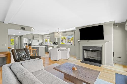 a living room with a couch and a fireplace at New Listing! Seagrove Villa 3A - Luxurious Ocean View! in Isle of Palms