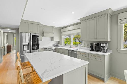 a kitchen with white cabinets and a white counter top at New Listing! Seagrove Villa 3A - Luxurious Ocean View! in Isle of Palms