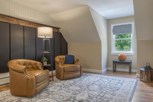 a living room with two chairs and a table at Game On! 4br Near Acadia Wfire Pit, Games & More in Ellsworth