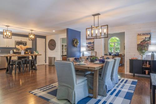 a dining room and living room with a table and chairs at Game On! 4br Near Acadia Wfire Pit, Games & More in Ellsworth