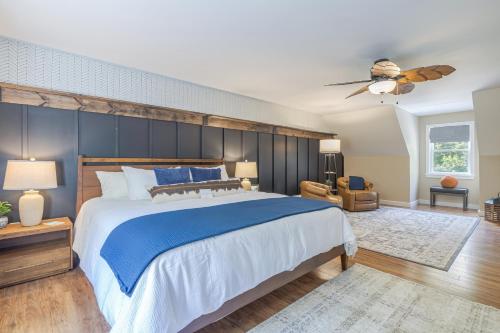 a bedroom with a large bed and a ceiling fan at Game On! 4br Near Acadia Wfire Pit, Games & More in Ellsworth