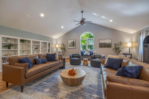a large living room with couches and a table at Game On! 4br Near Acadia Wfire Pit, Games & More in Ellsworth