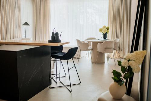 a kitchen with a table and chairs in a room at By the lake apartment in Ostróda