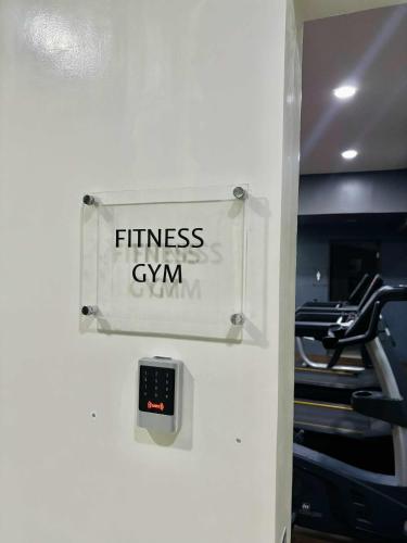 a sign that reads fitness gym on a wall at Suite Escapes at Brenthill Baguio in Baguio