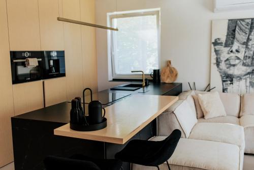 a living room with a table and a couch at By the lake apartment in Ostróda