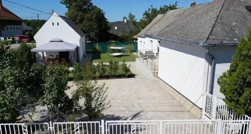 an aerial view of a white house with a white fence at Varázsvilág Vendégház in Olaszfalu