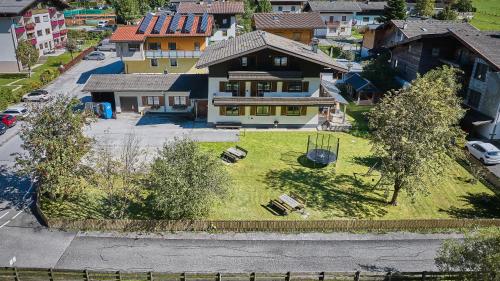an aerial view of a house with a yard with a swing at Apartments Enzian in Rauris