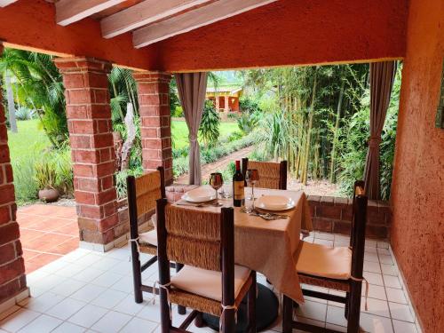 a dining room with a table and chairs on a patio at Portal Azahualco Bungalow 1 close to the mountain in Tepoztlán