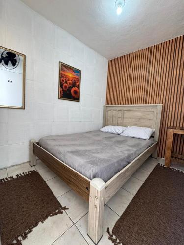 a bedroom with a large bed in a room at Pousada Mãe Linda in Aparecida