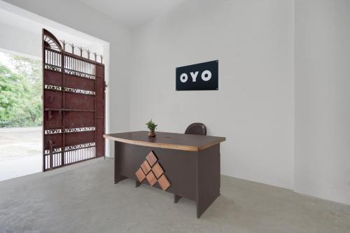 an office with a desk with a sign on the wall at SPOT ON Rs Hotel in Sītāpur