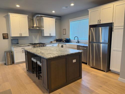 a kitchen with white cabinets and a granite counter top at 2Bd Twilight Retreat near Silos, Clemson & Greenville in Easley