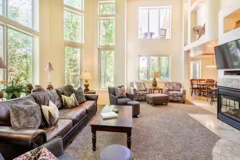 a living room with a couch and a tv at Spectacular Driggs Townhome with Hot Tub in Driggs