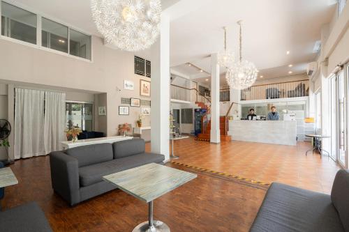 a living room with a couch and a table at Ratchadamnoen Residence in Bangkok