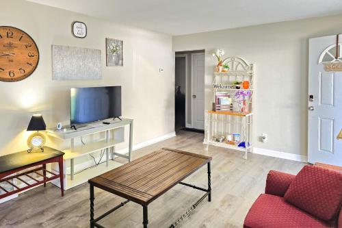 a living room with a couch and a tv at 2BR Retreat with Fire Pit Close To Downtown STL in Saint Ann