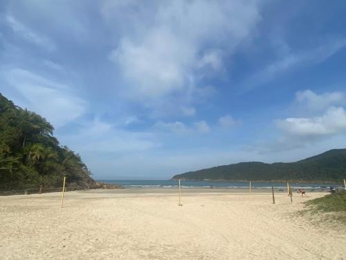a sandy beach with volleyball nets on it at Pousada Praia do Guaiuba in Guarujá