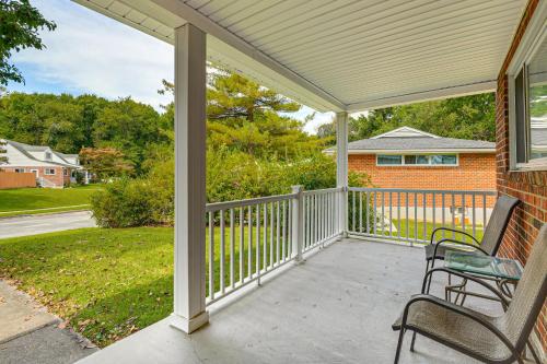 a screened porch with two chairs on a house at 5 Mi to Downtown Baltimore Quiet Home with Porch in Rosedale