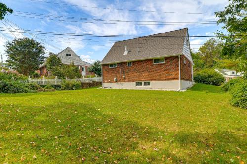 a large brick house in a field of grass at 5 Mi to Downtown Baltimore Quiet Home with Porch in Rosedale