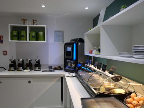 a kitchen with a sink and a counter top at ibis Styles Saint Julien en Genevois Vitam in Neydens