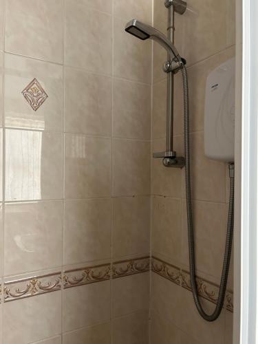 a shower with a shower head in a bathroom at Cadeby Lodge in Blackpool