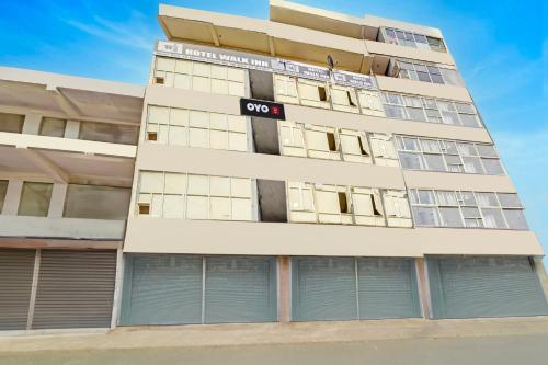 an apartment building with a no sign on it at Hotel O Walk Inn in Kalkaji Devi